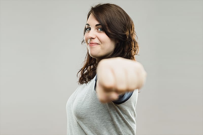 Woman pointing fist at camera