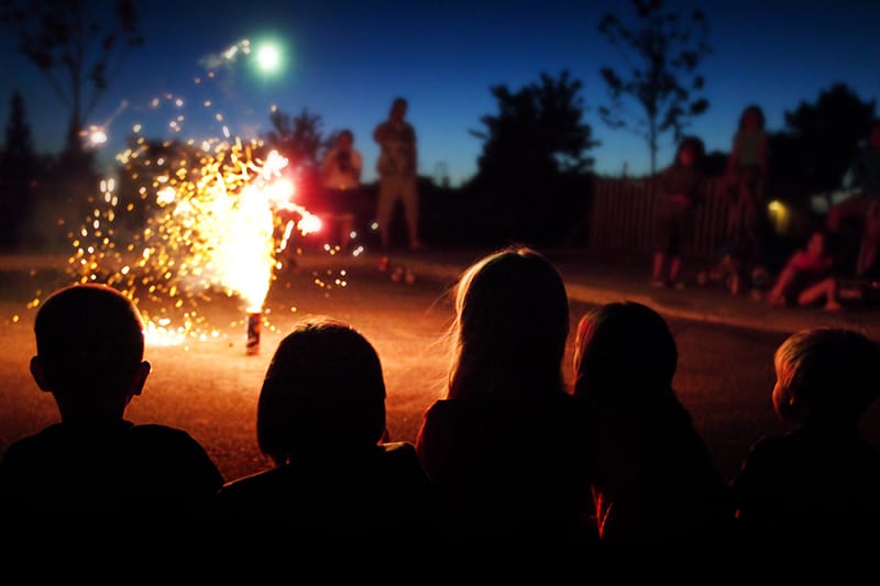 Kids sitting together, watching fireworks