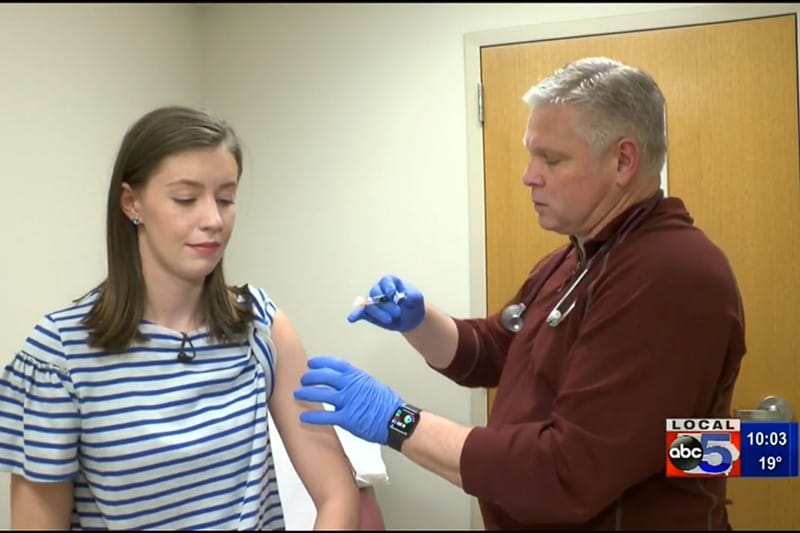 Woman receiving a flu shot from Frank Raymond, PA-C