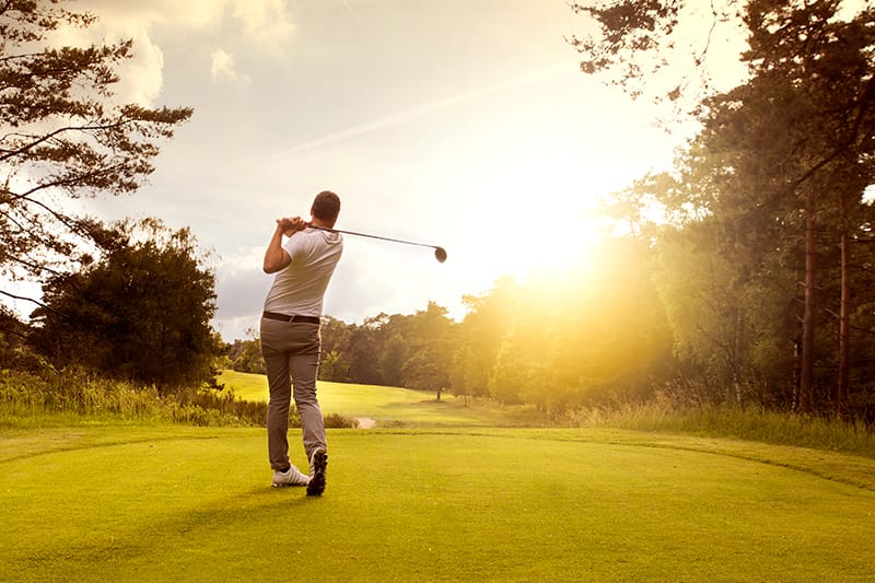 Man on golf course after just teeing off
