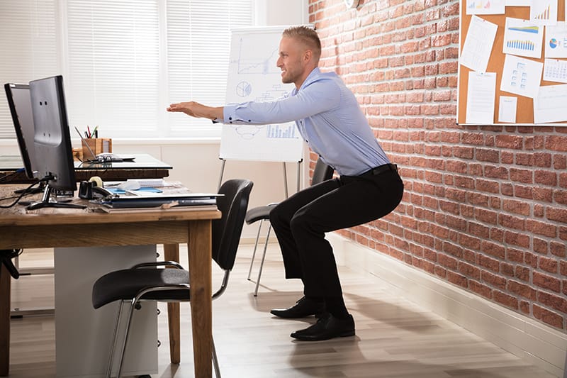 Man holding a squat while at work