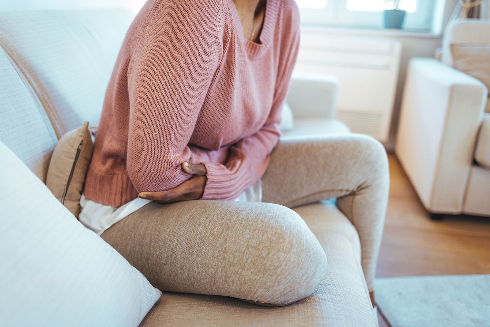 woman holding her abdomen in pain