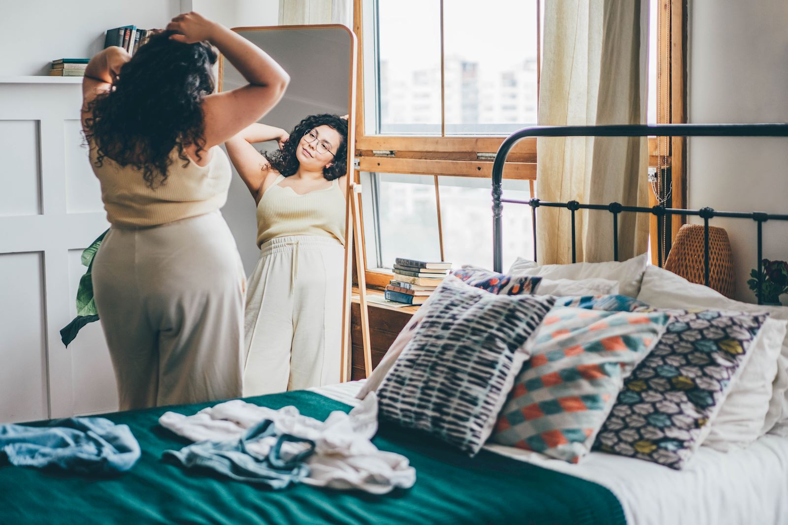 woman looking at herself in the mirror