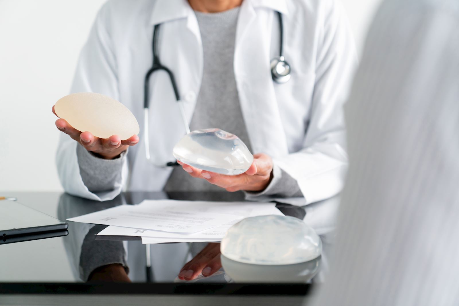 doctor holding breast implants