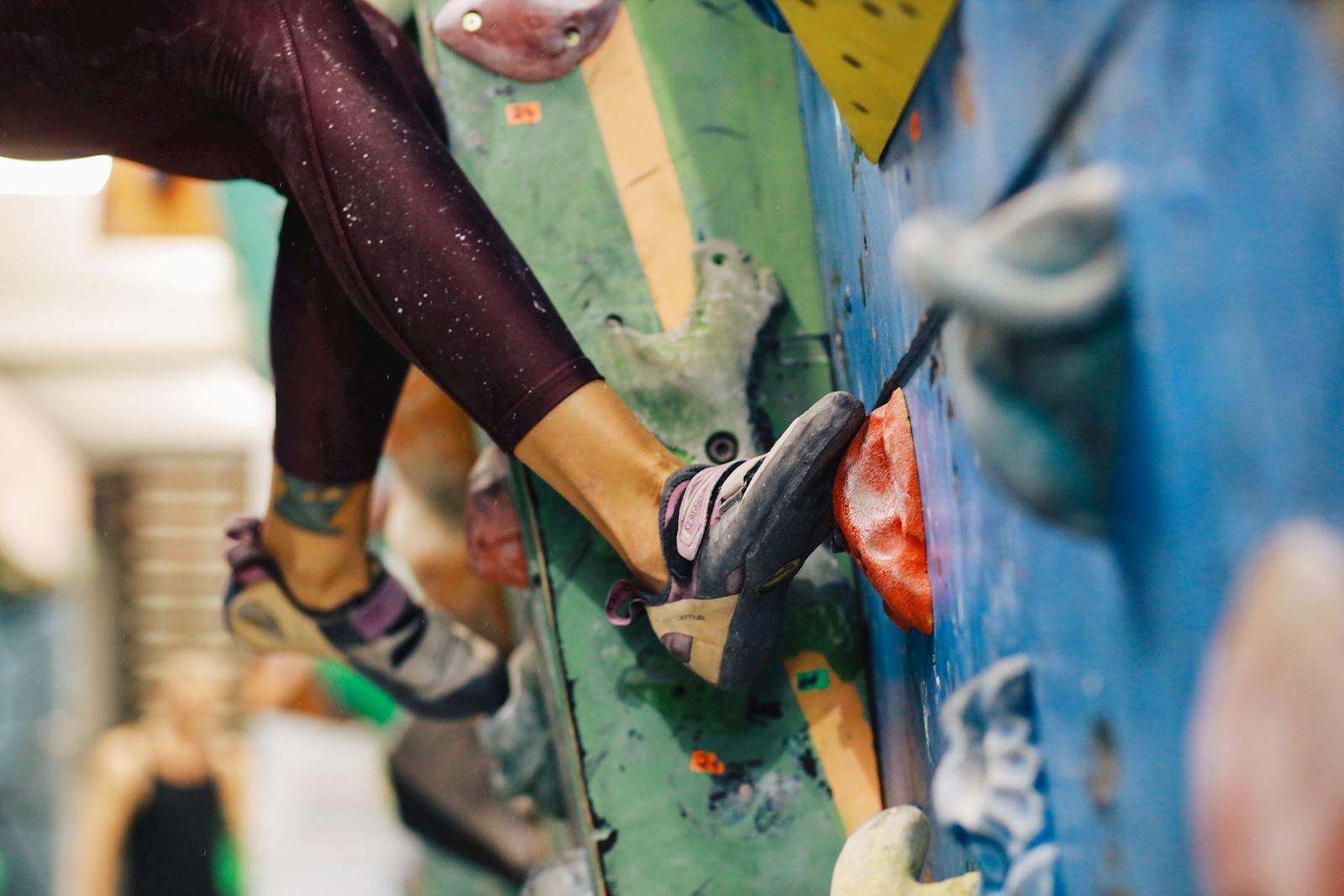 woman on an indoor rock climbing wall