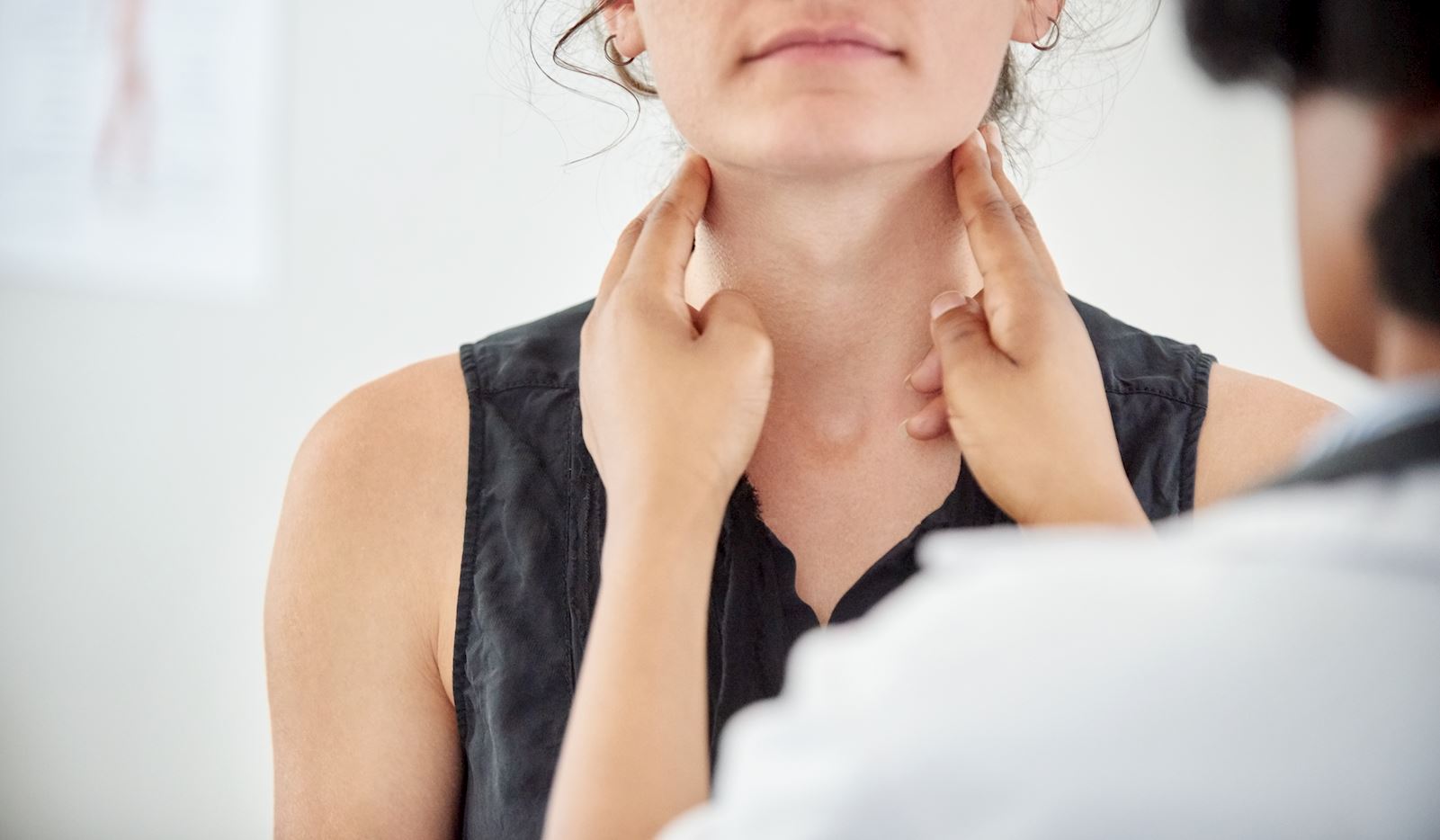 doctor examining patient neck