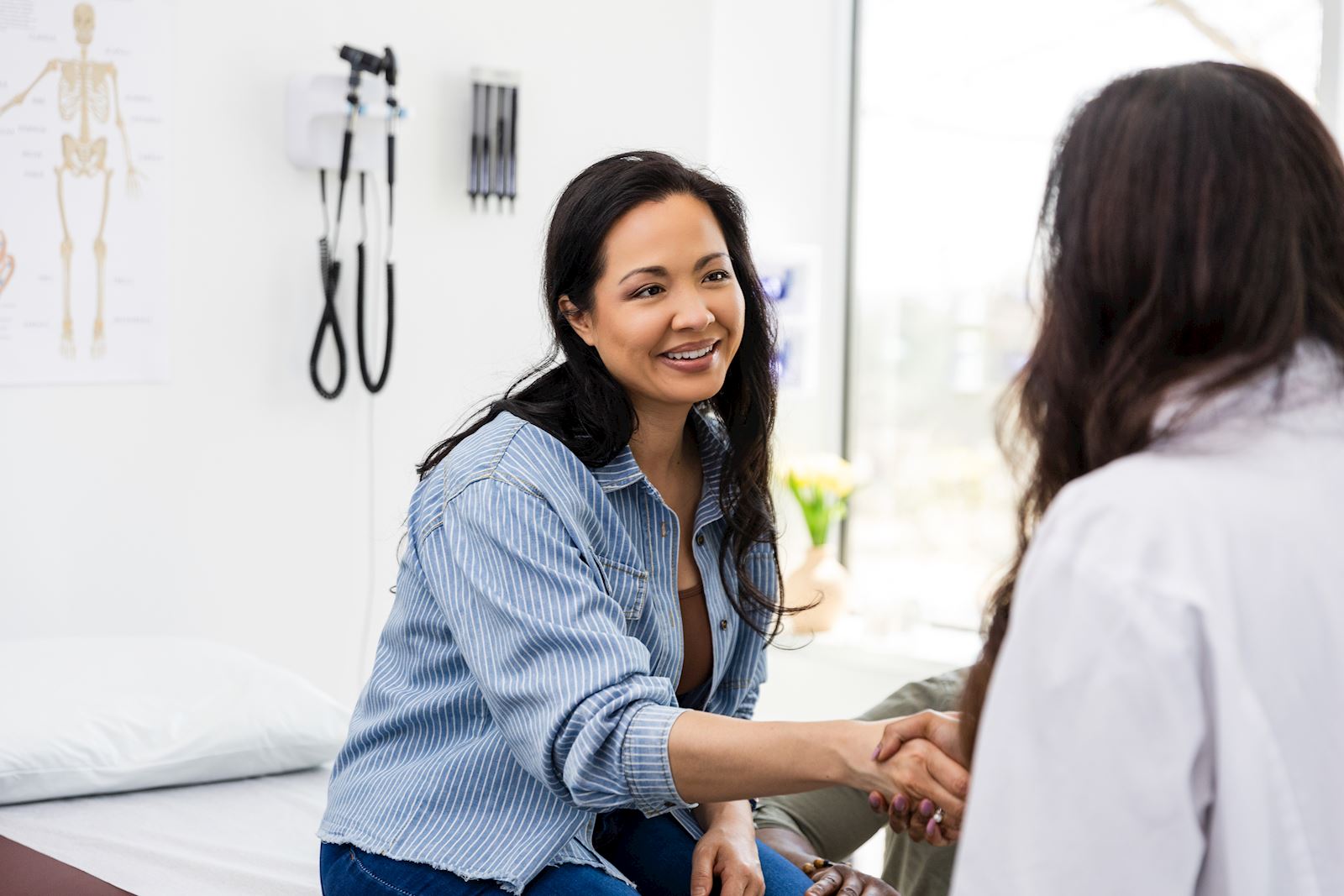 woman speaking with provider in exam room