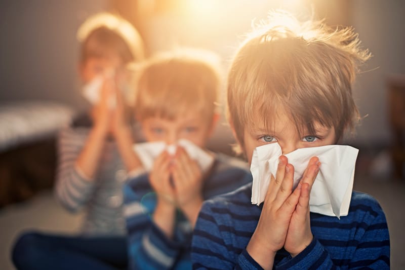 child blowing nose