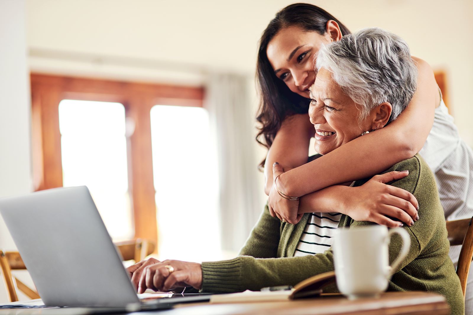 young woman hugs older woman