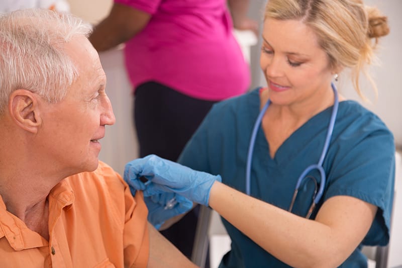 nurse gives patient vaccine