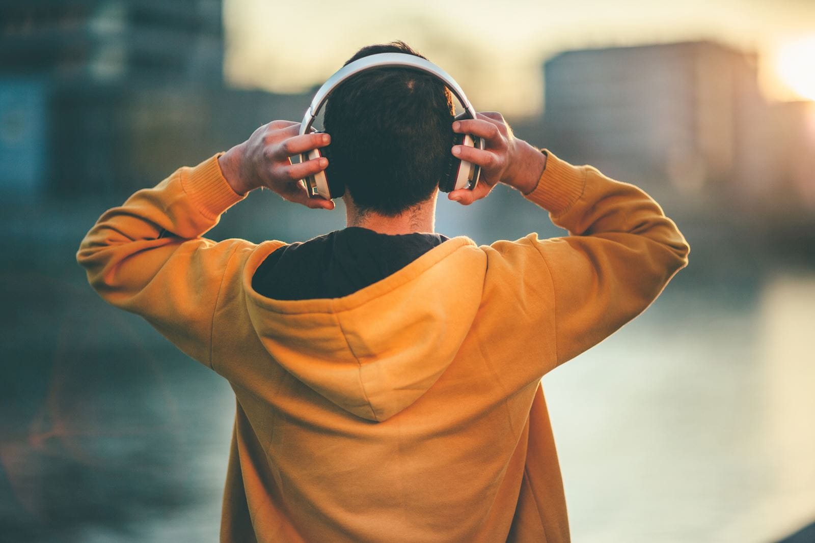 man holding headphones on his head