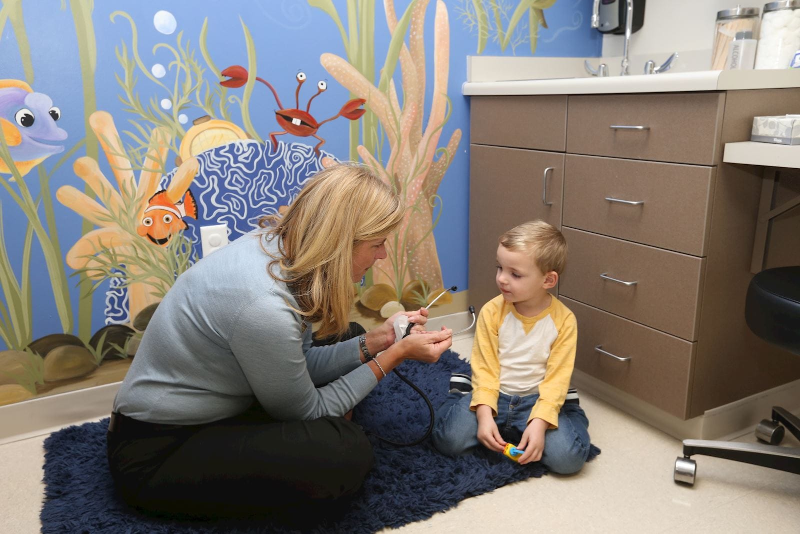 Pediatrician talking with child