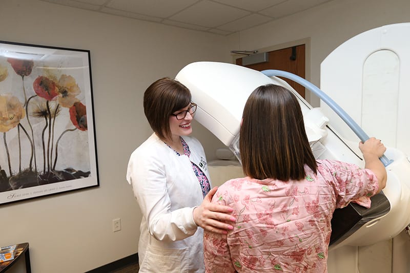 Provider helping a patient with a mammogram
