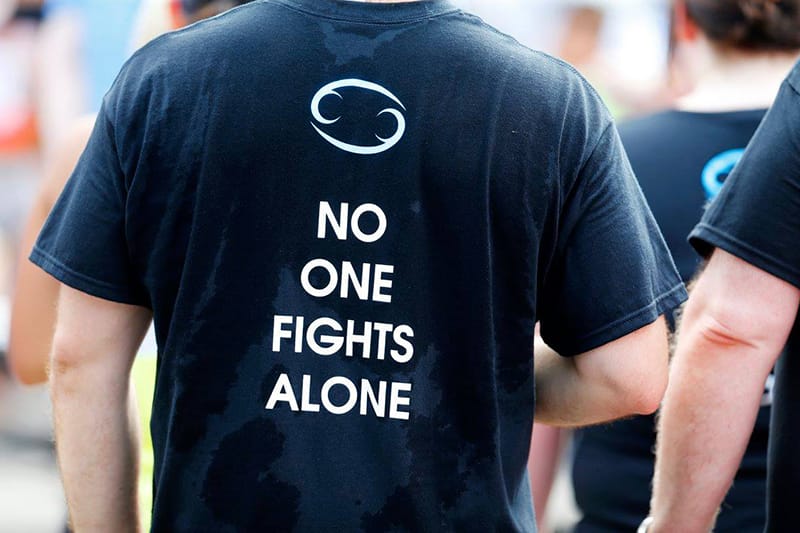 Person wearing a shirt that says 'no one fights alone'