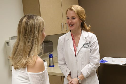 Dermatologist speaking with patient