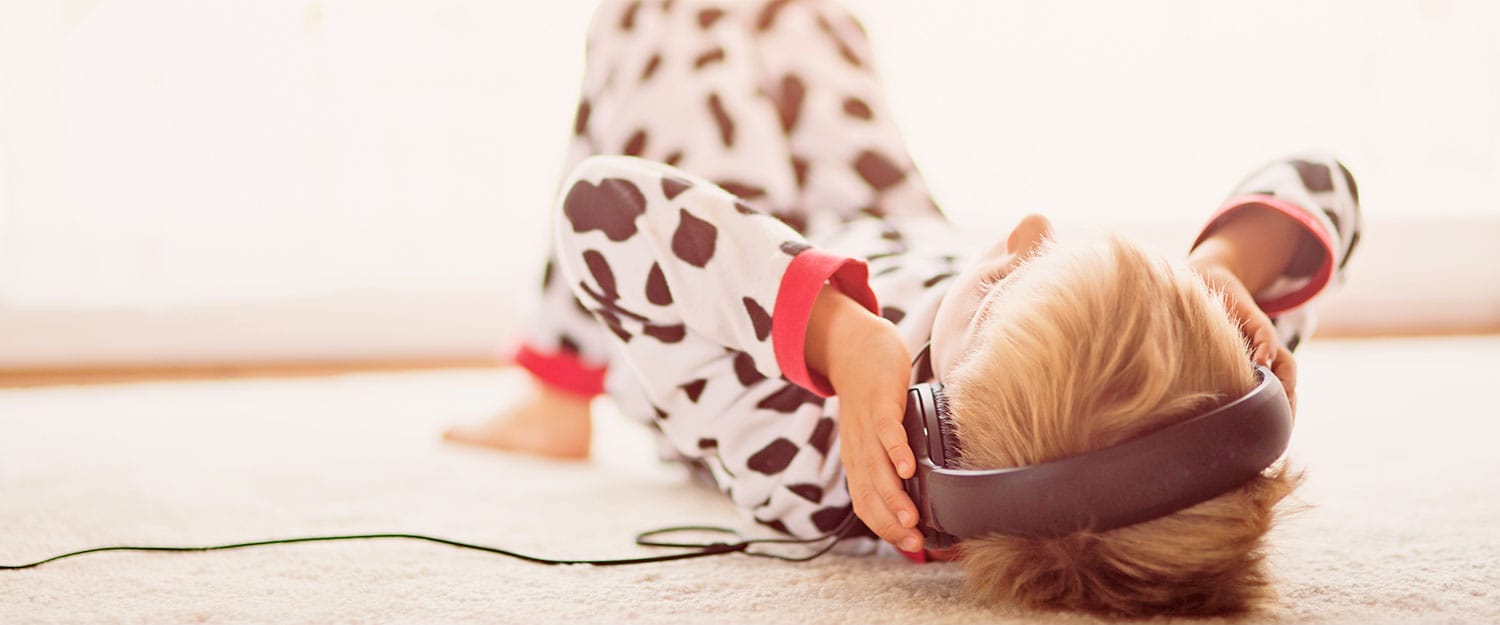 Child on floor with headphones