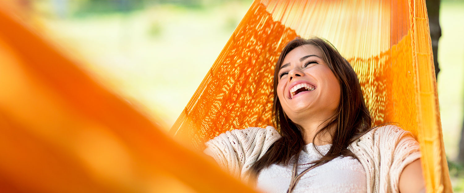 Woman laughing in hammock