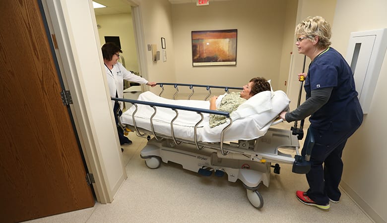 Endoscopy Center - patient in bed being wheeled to exam room
