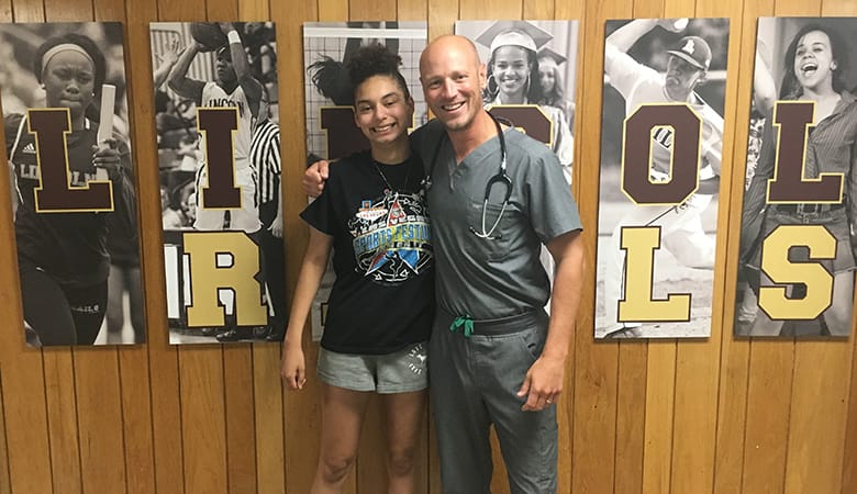 doctor embracing athlete