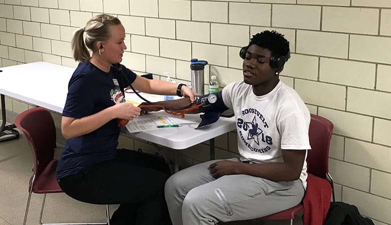 nurse checking heart rate of athlete