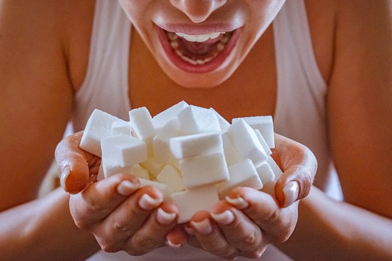 Woman with handful of sugar